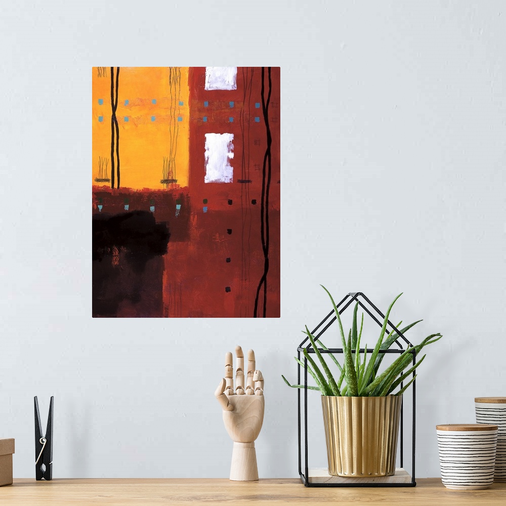 A bohemian room featuring Vertical abstract of red and yellow with small boxes in horizontal rows and croaked vertical line...