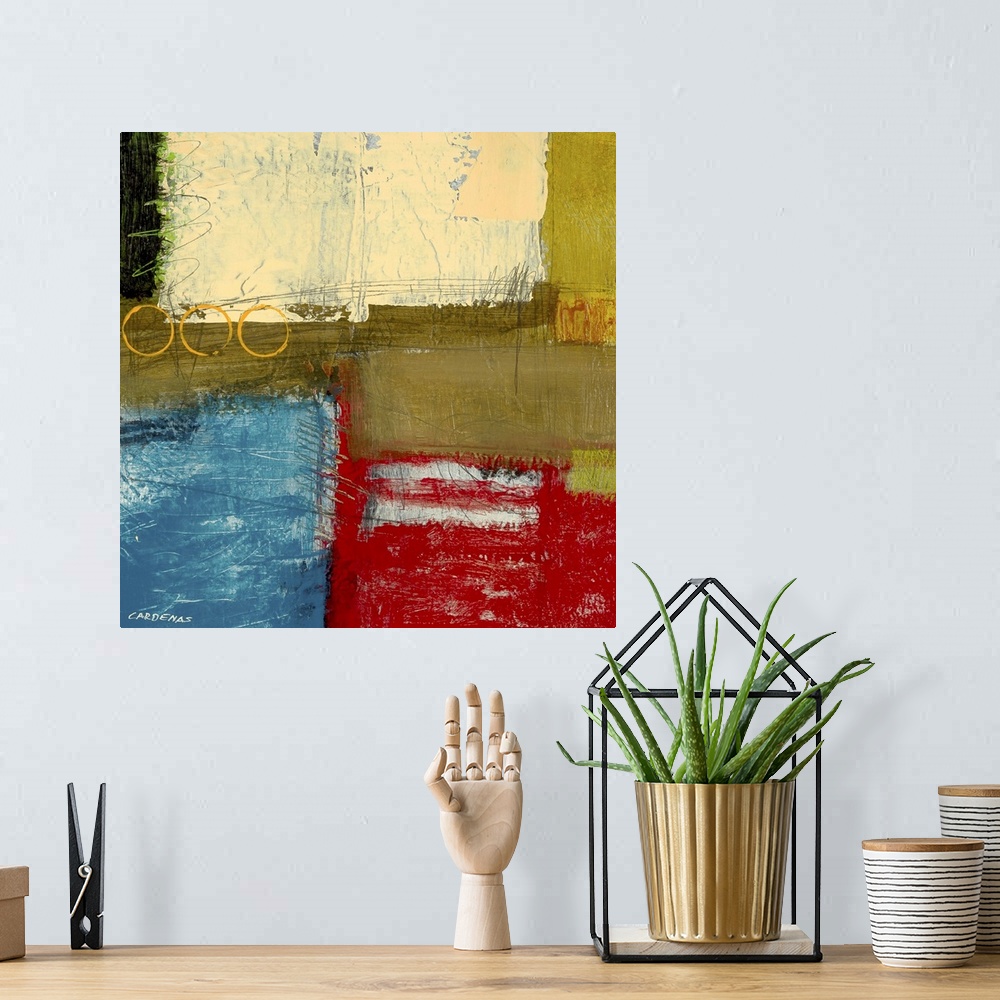 A bohemian room featuring Red, beige, green and blue abstract.