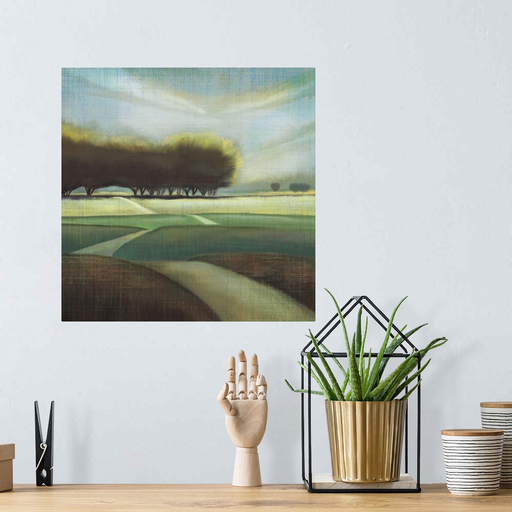 A bohemian room featuring Contemporary artwork of large trees in a hilly landscape with a narrow road.