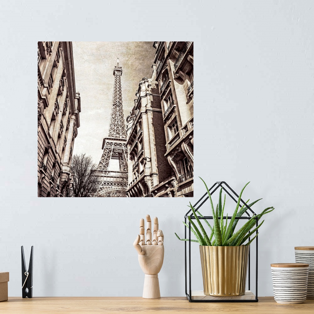 A bohemian room featuring A square photo of the Eiffel Tower from the street in a sepia tone and a textured effect overlay.