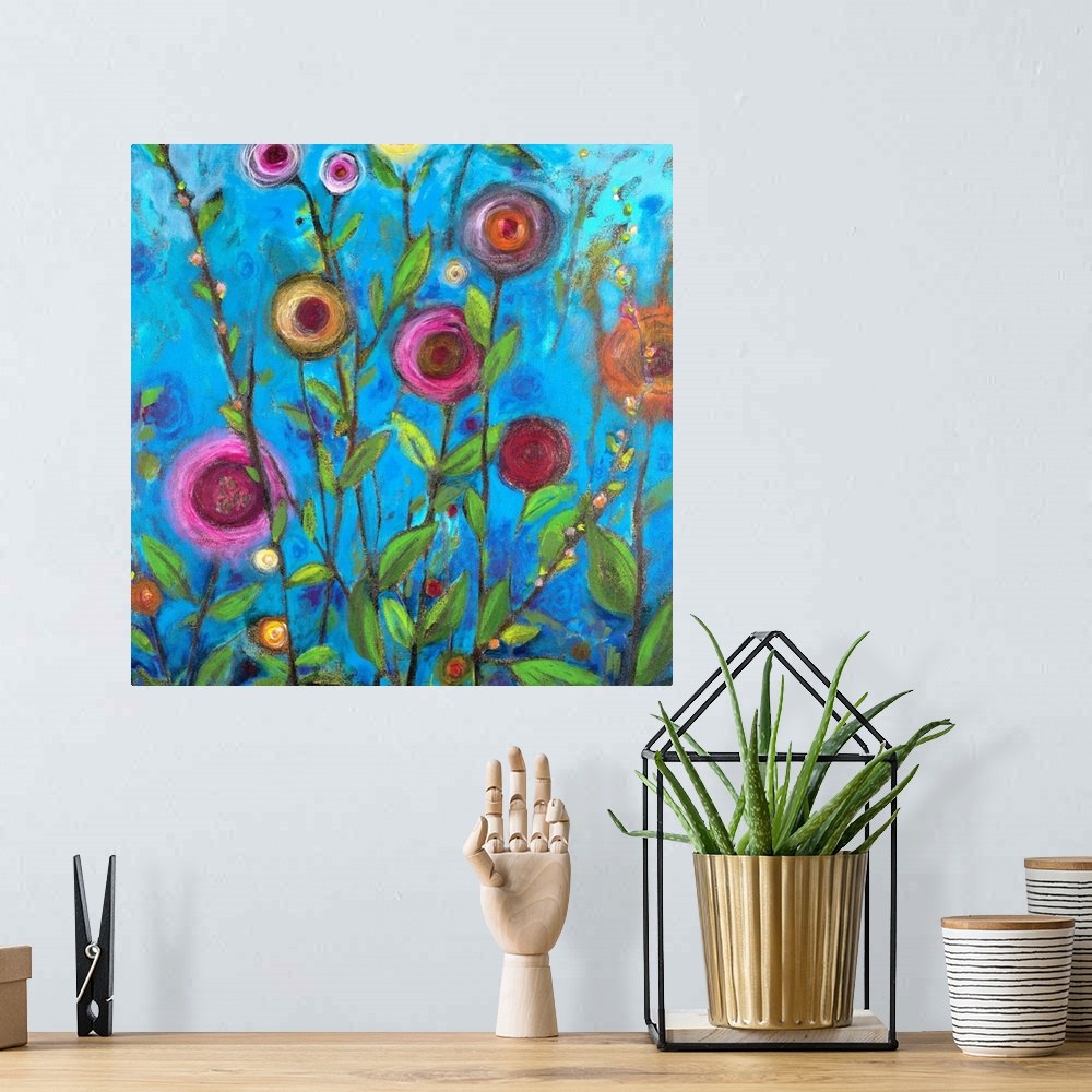 A bohemian room featuring Square complementary painting of multi-colors of buttercup flowers upon a blue backdrop.