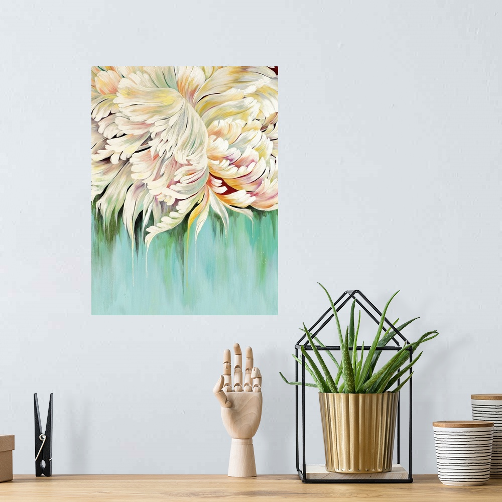 A bohemian room featuring A complementary painting of a large white blooming flower, with hints of yellow and red.