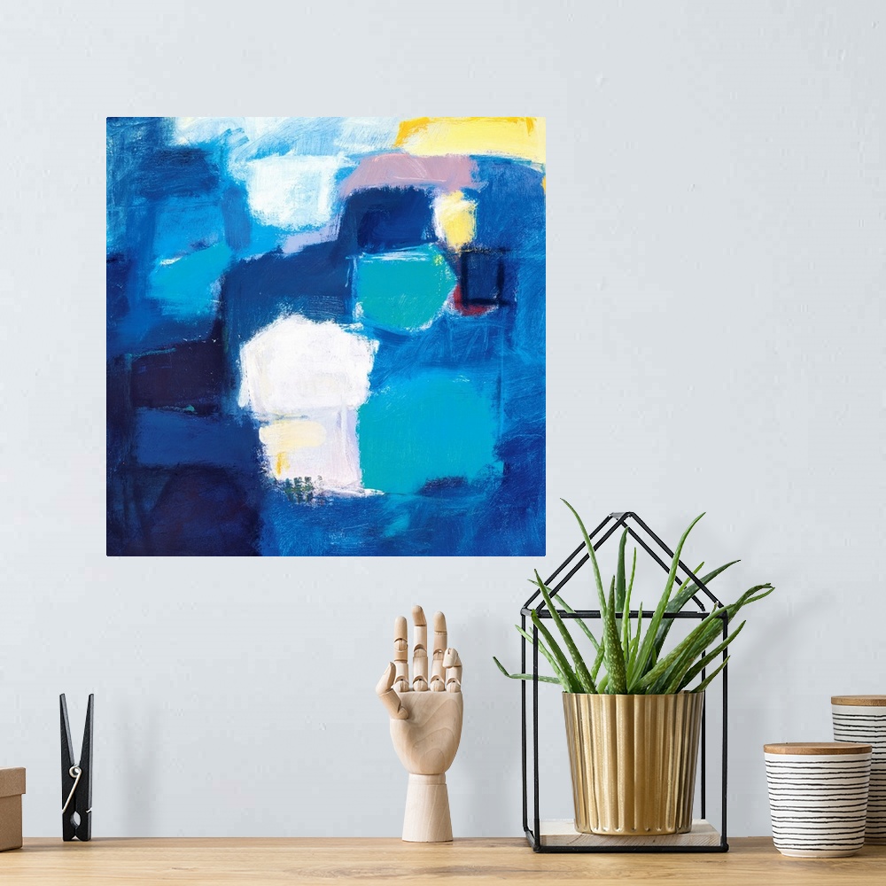 A bohemian room featuring A modern abstract painting of square style shapes in shades of blue with accent colors of yellow ...