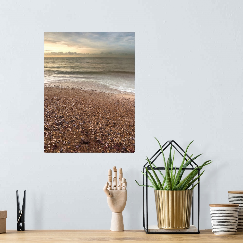 A bohemian room featuring Vertical photograph of a pebble covered beach with gentle waves.