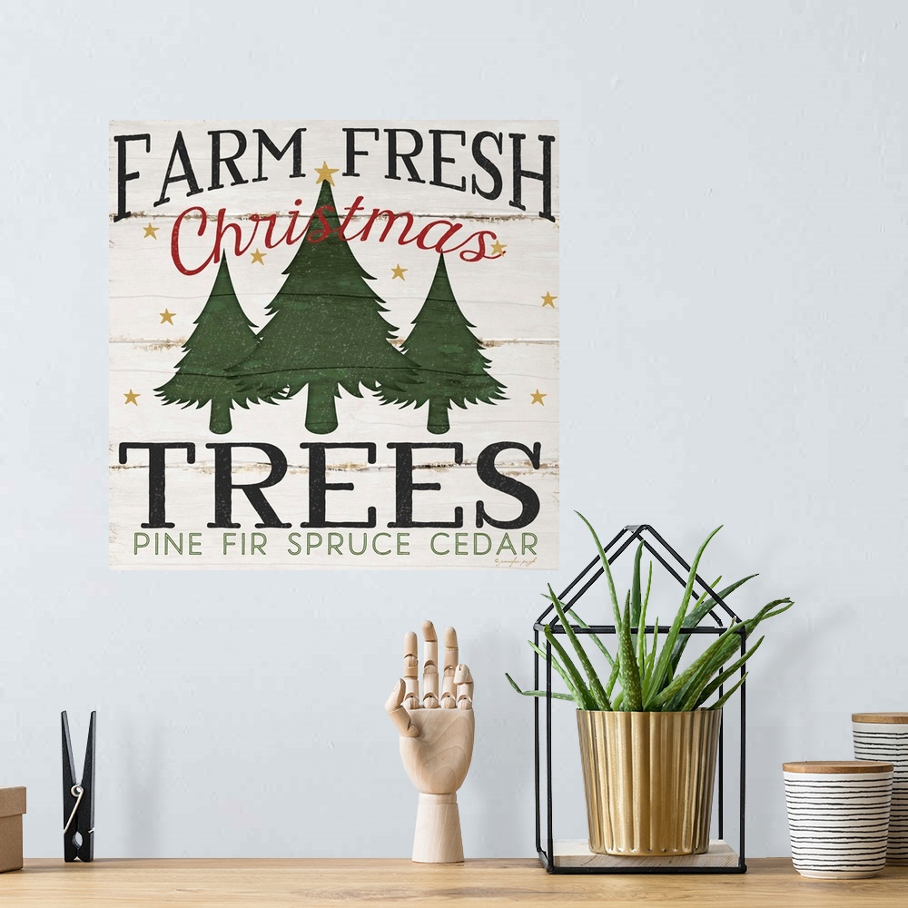 A bohemian room featuring Christmas themed typography artwork in festive seasonal colors.