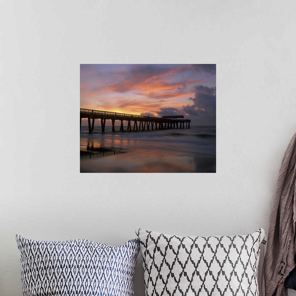 A bohemian room featuring Georgia Tybee Island, pier at sunrise with reflections of clouds on beach.