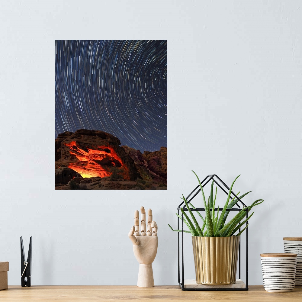 A bohemian room featuring Usa, Nevada. Valley of Fire State Park, star trails and campfire glowing in sandstone rocks.
