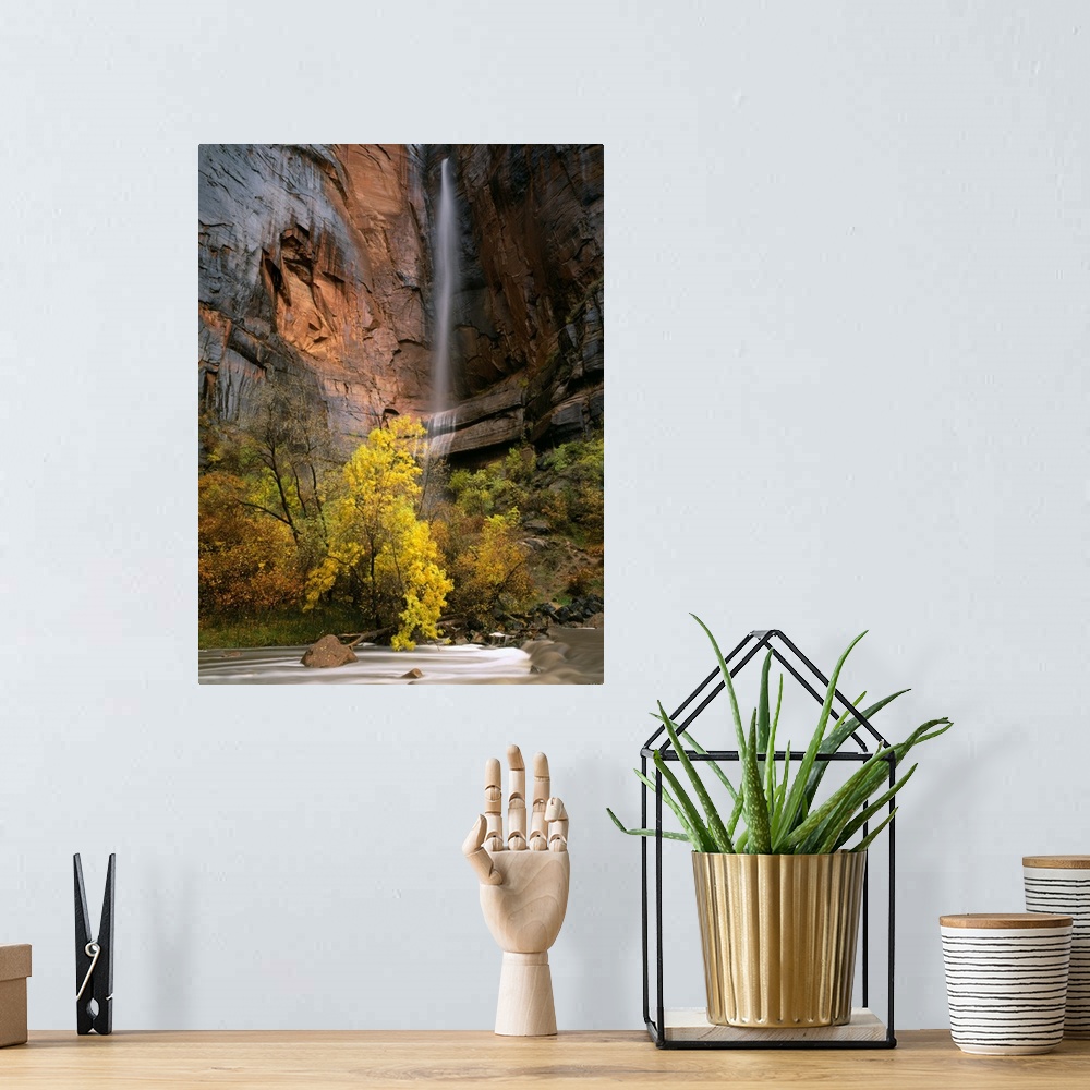 A bohemian room featuring Zion National Park, Utah. Ephemeral waterfall pours over cliff above Virgin River during autumn r...