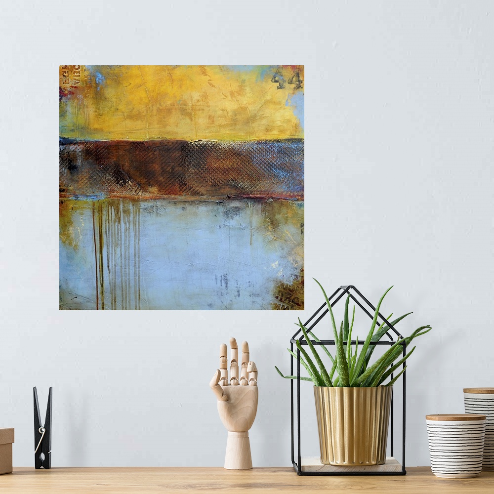 A bohemian room featuring Contemporary abstract painting of a color-field of weathered yellow brown and pale blue tones.