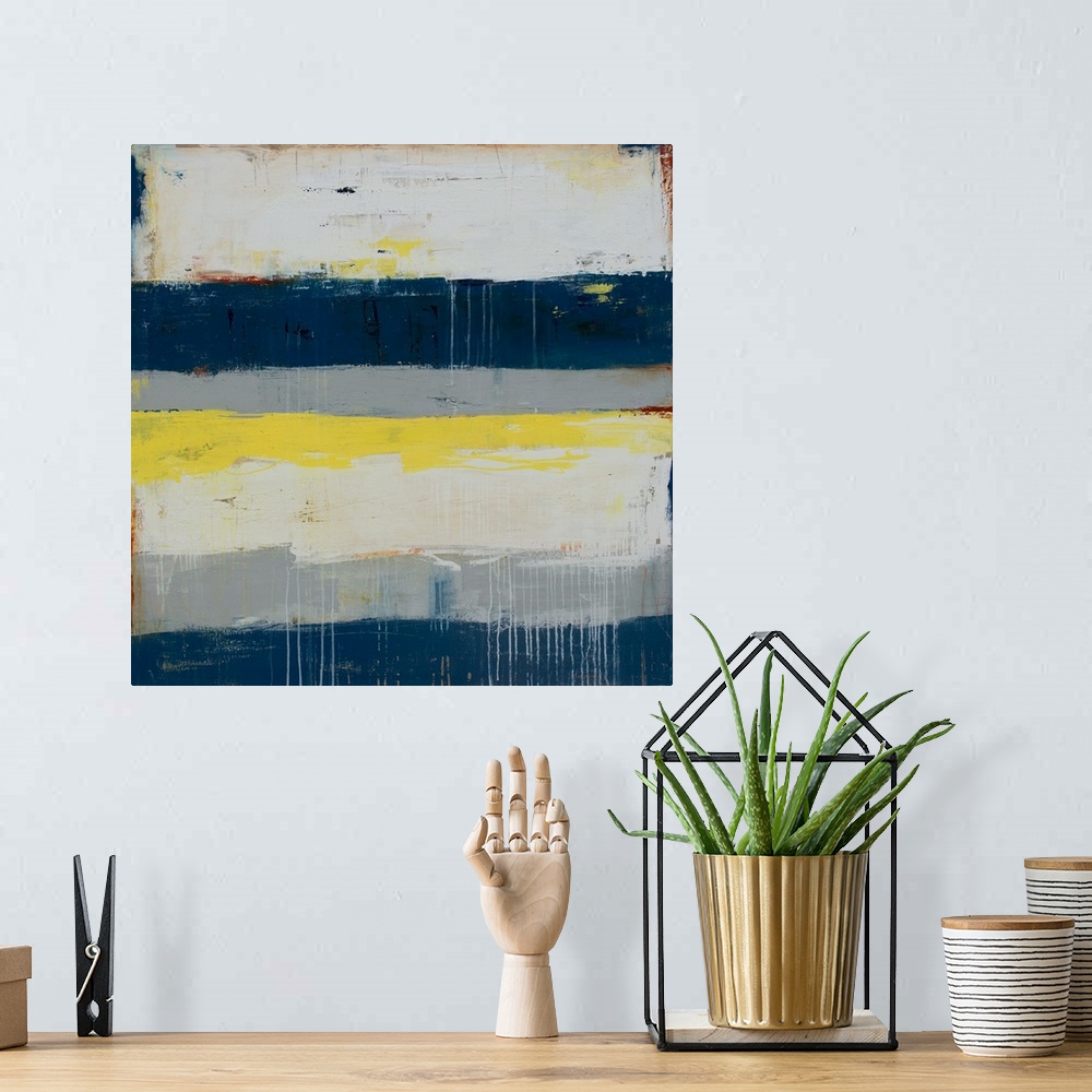 A bohemian room featuring Horizontal striped abstract painting in shades of gray, blue, and yellow, with paint drips on top...