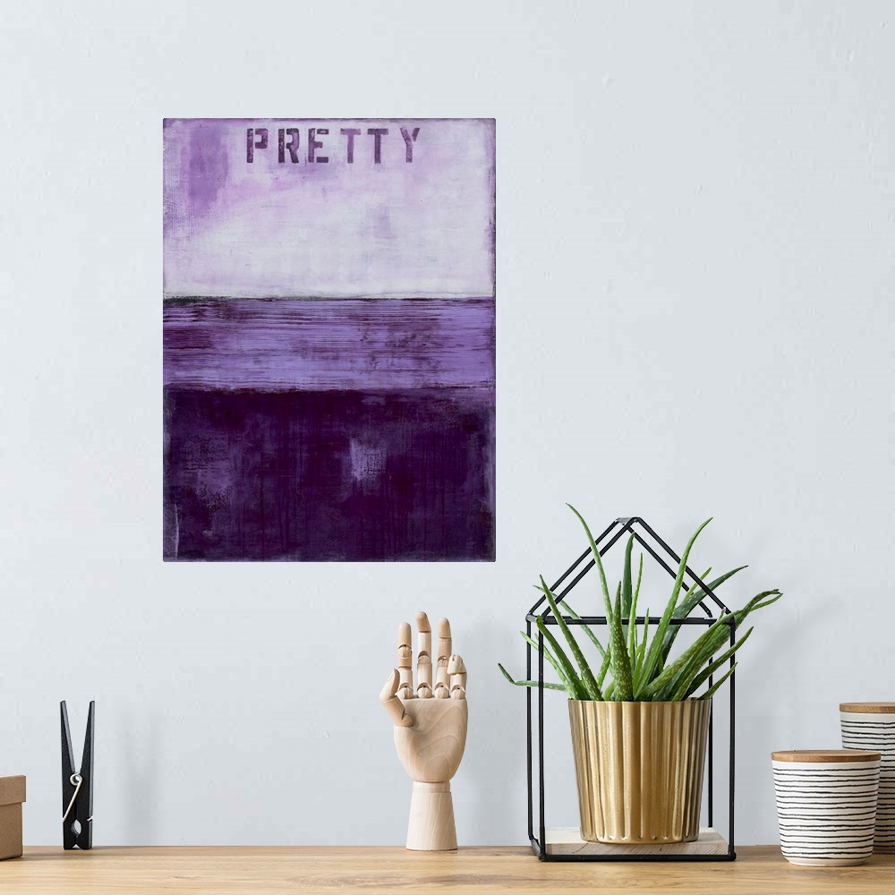 A bohemian room featuring Vertical abstract artwork created with different shades of purple and the word "Pretty" stenciled...