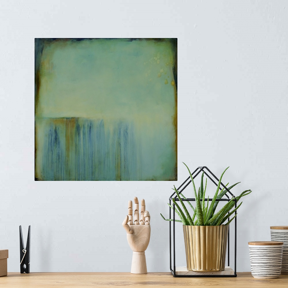 A bohemian room featuring Square abstract painting created with a muted blue turning into green with streaking lines in bro...