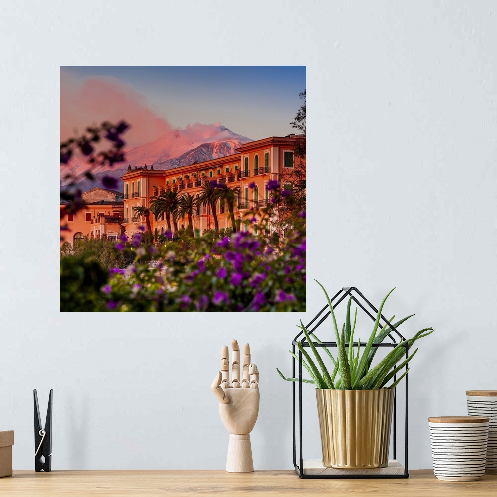 A bohemian room featuring Italy, Sicily, Messina district, Taormina, San Domenico Palace Hotel at sunset with Mount Etna in...