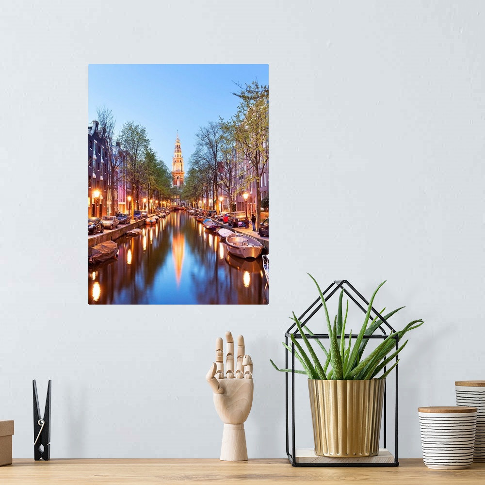A bohemian room featuring Netherlands, North Holland, Benelux, Amsterdam, Montelbaan Tower at Oude Schans illuminated at dusk.
