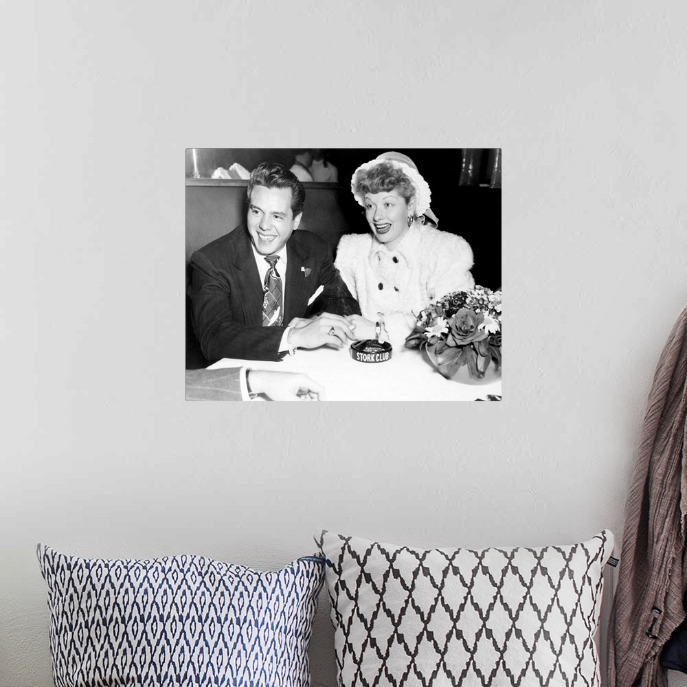 A bohemian room featuring Black and white photograph of Desi Arnaz and Lucille Ball.