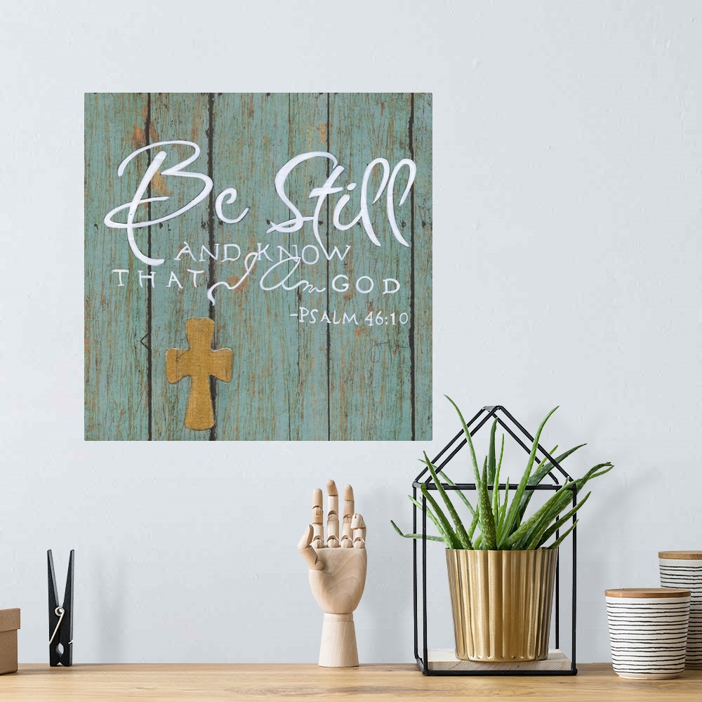 A bohemian room featuring A decorative religious painting on a blue, aged wooden background that has the quote from Psalm 4...