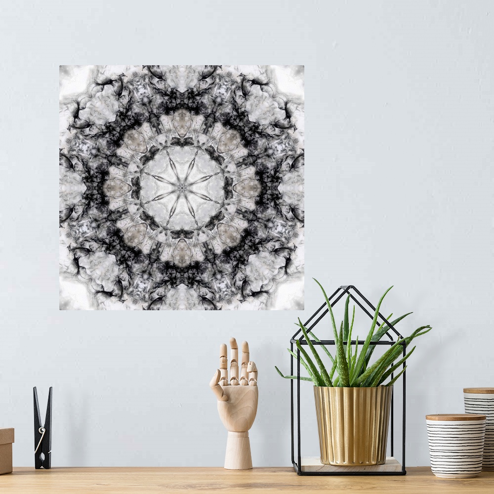 A bohemian room featuring Square abstract art in black and white hues with kaleidoscope-like patterns and designs.