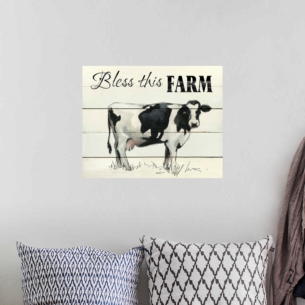 A bohemian room featuring "Bless This Farm" written on the top of a faux wood background with a painting of a cow at the bo...