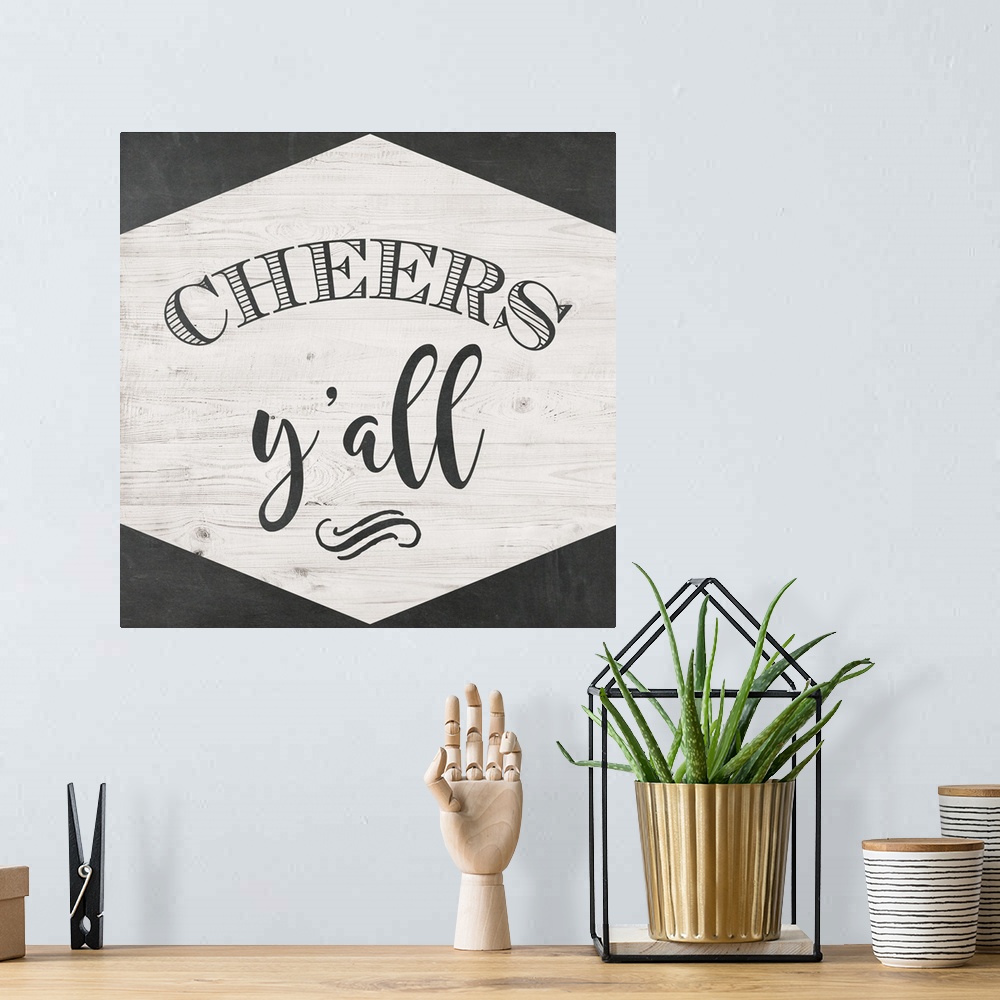 A bohemian room featuring The words "Cheers Y'all" are black lettering placed on a white shiplap trimmed with chalkboard te...