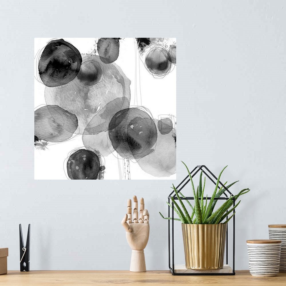 A bohemian room featuring Abstract watercolor painting of circular shapes in shades of grey.