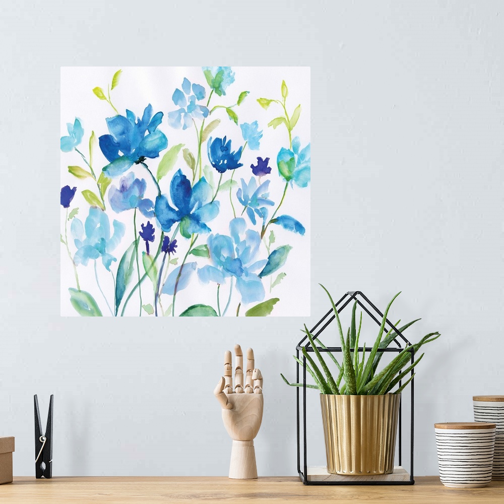 A bohemian room featuring Bright blue watercolor flowers with green leaves spring up against a white background.