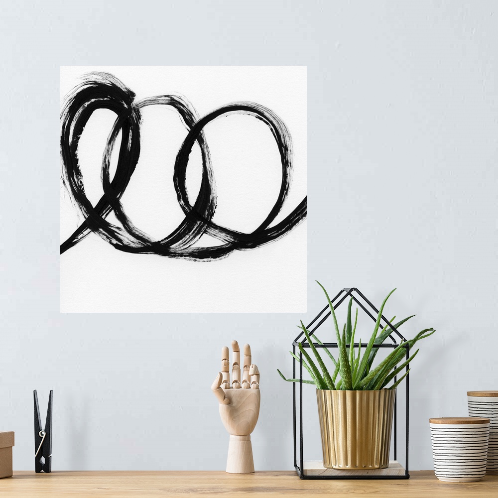 A bohemian room featuring Square black and white abstract painting with a thick, bold, loopy line.