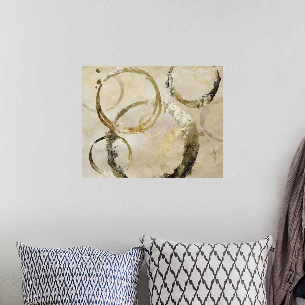 A bohemian room featuring Geometric abstract painting with distressed golden, dark gray and beige rings against a neutral t...