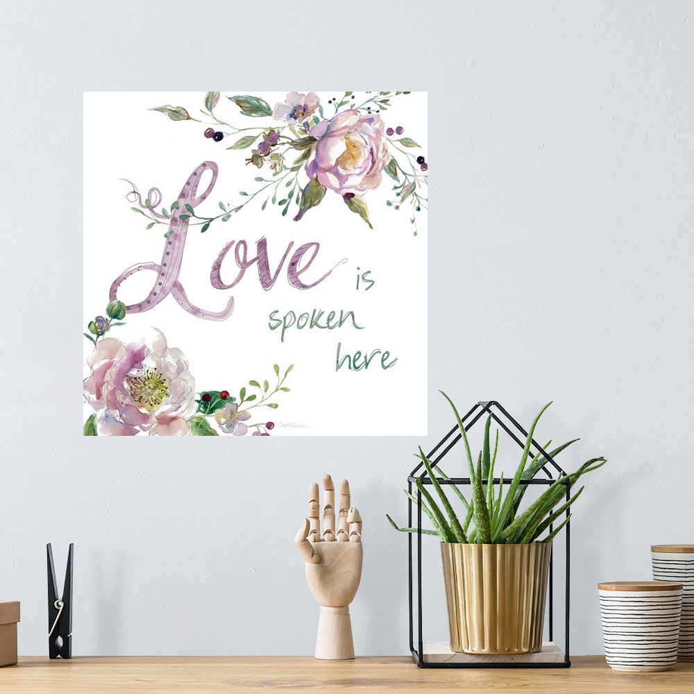 A bohemian room featuring "Love is Spoken Here" with water color flowers.