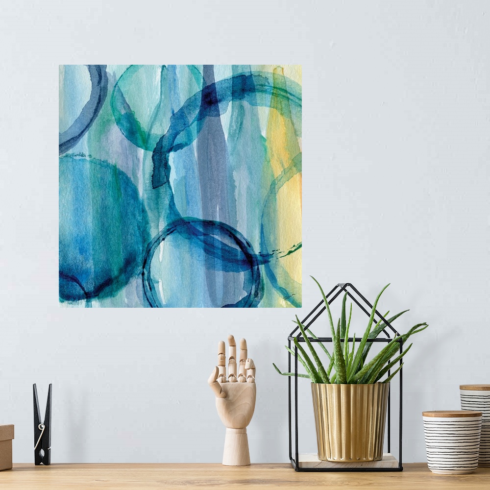 A bohemian room featuring Contemporary watercolor painting of rich blue rings on a blue and yellow background.
