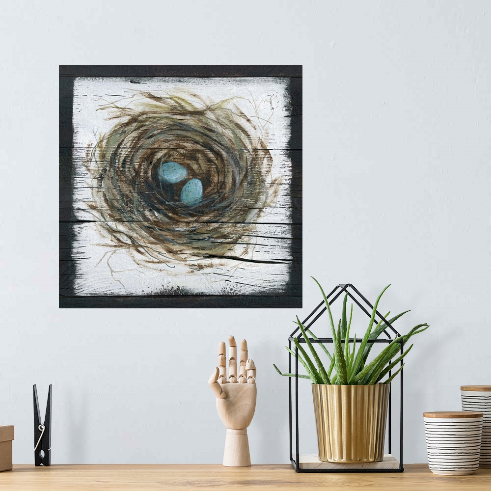 A bohemian room featuring A wooden painting of a bird's nest with two eggs inside.