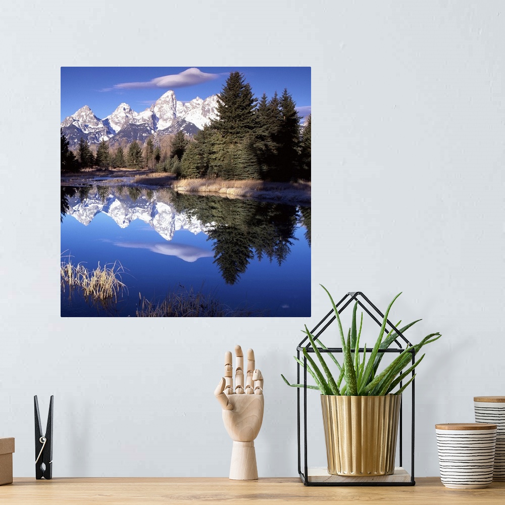 A bohemian room featuring The Grand Tetons in Wyoming reflected in the lake below.