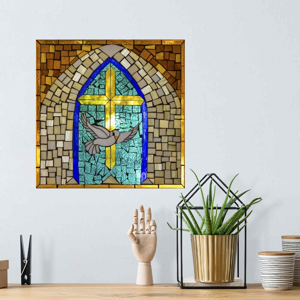 A bohemian room featuring Artwork done in a stained-glass style depicting a cross and dove, symbols of Christianity.