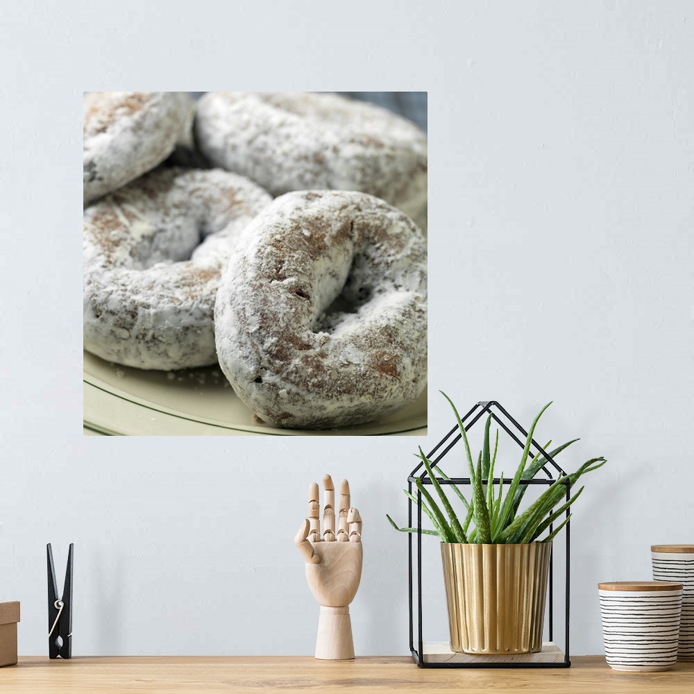 A bohemian room featuring A plate of sugar donuts aka 'doughnuts'