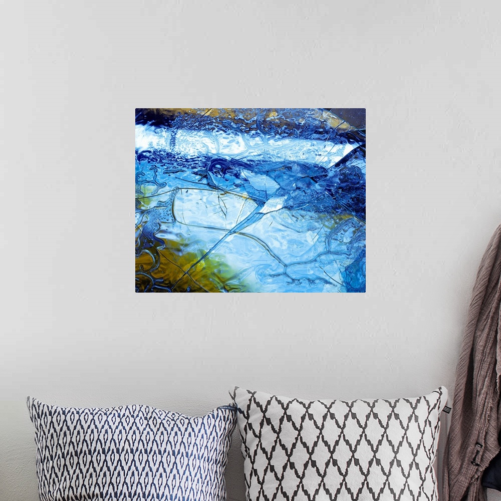 A bohemian room featuring Abstract artwork of a sheet of ice that has cracked and been shattered in one spot.