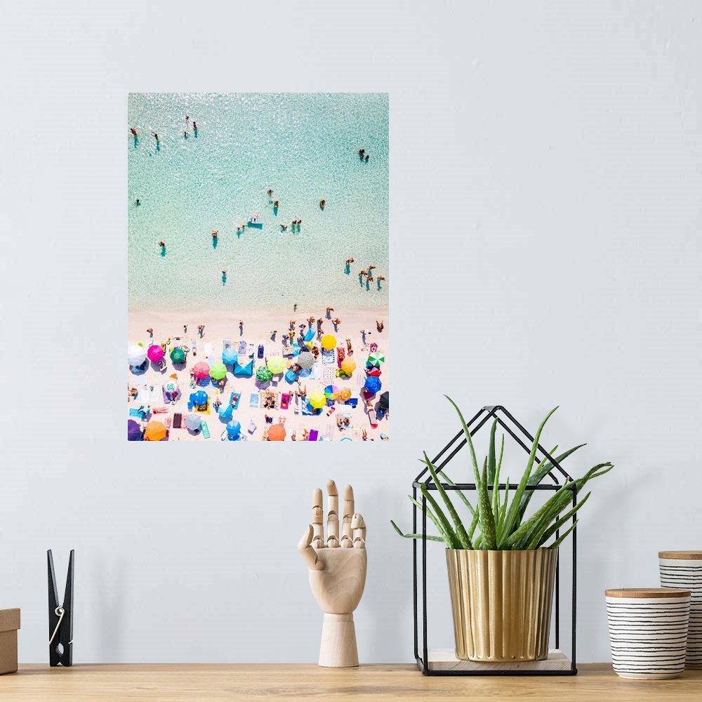 A bohemian room featuring Aerial view of a white beach full of colored beach umbrellas and relaxed people swimming on a cle...
