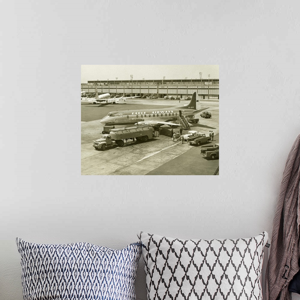 A bohemian room featuring Airplane getting refuelled on airport runway, (B&W), (Elevated view)