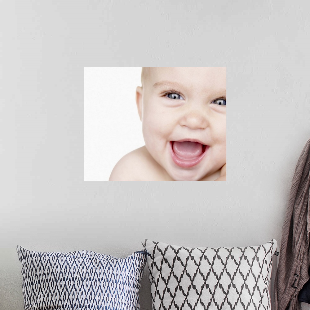 A bohemian room featuring Baby boy (6-9 months) laughing, close up, portrait, studio shot