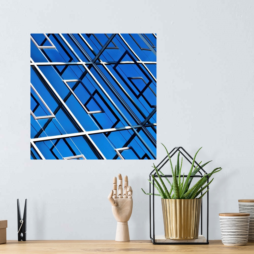 A bohemian room featuring Blue, abstract and geometric reflection on  facade of modern building.