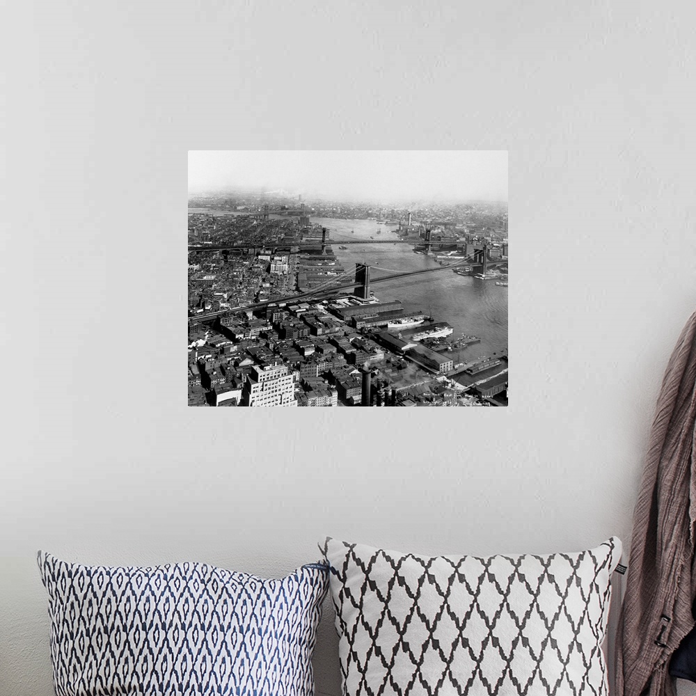 A bohemian room featuring A view up the East River with the Brooklyn, Manhattan and Williamsburg bridges as seen from Wall ...