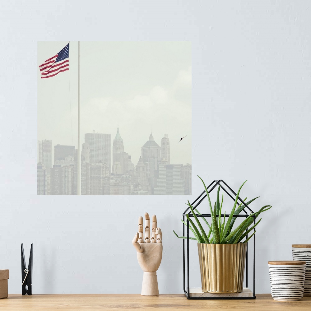 A bohemian room featuring Buildings of Manhattan with United States flag flying in foreground.
