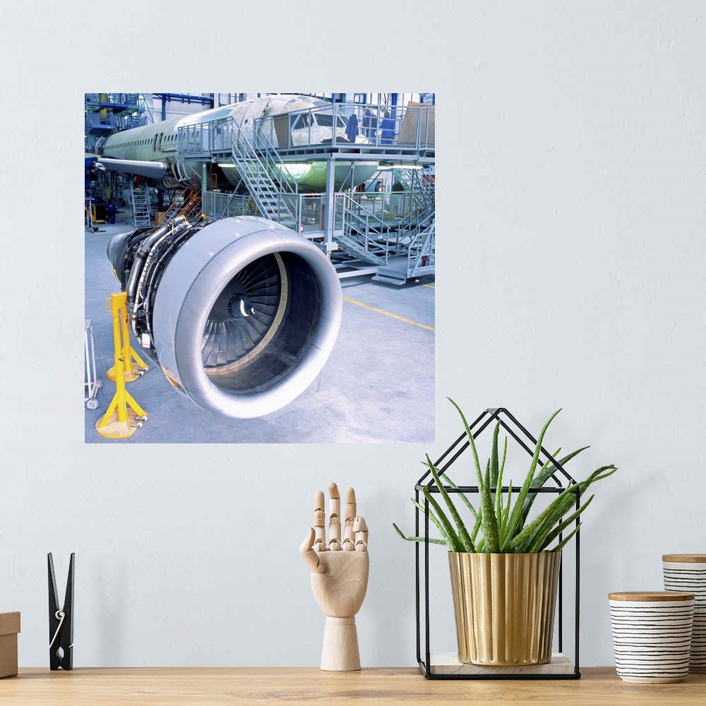 A bohemian room featuring close-up of an aircrafts engine turbine kept in a hanger for assembly