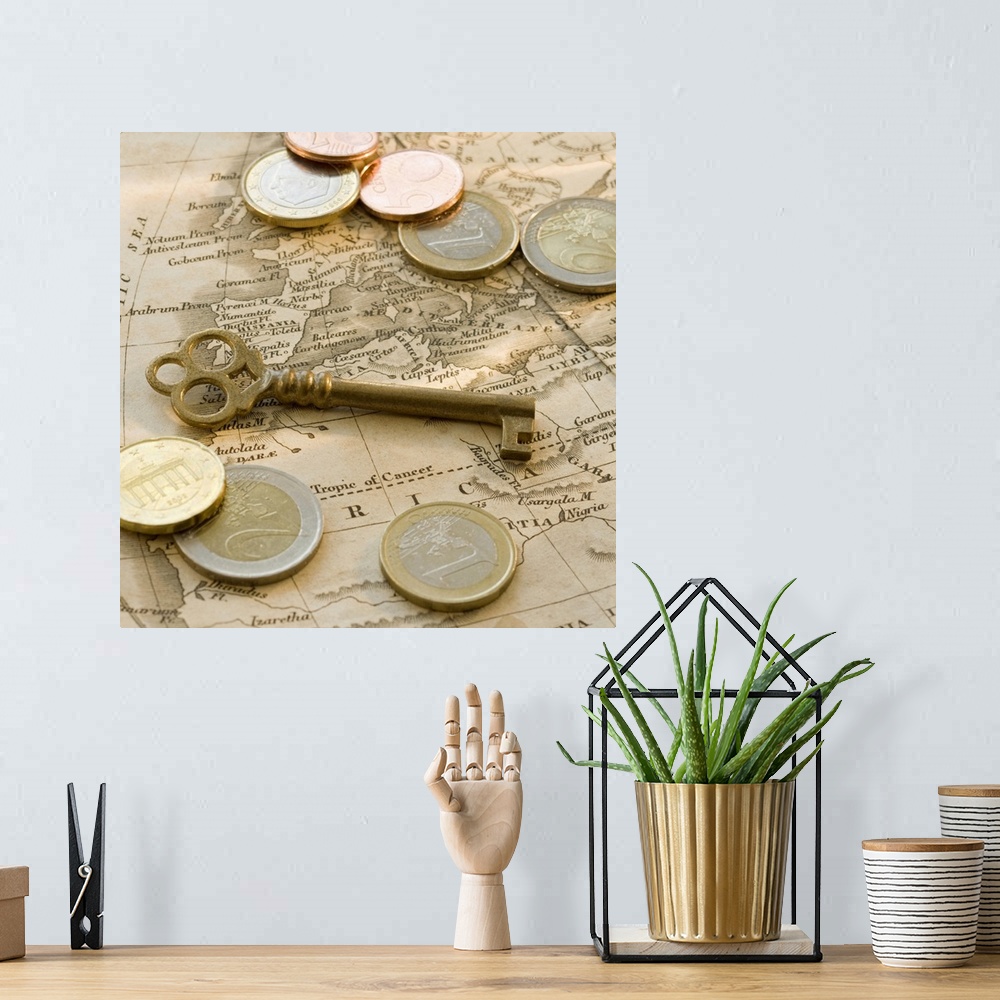A bohemian room featuring Close up of euro coins, map and antique key