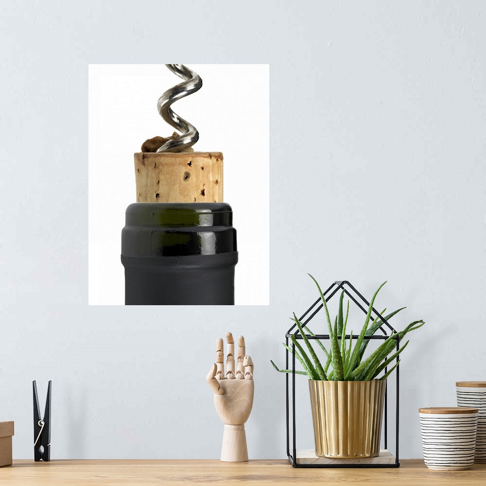 A bohemian room featuring Corkscrew and cork, photographed on white surface. Part of the bottle's neck can be seen too. The...