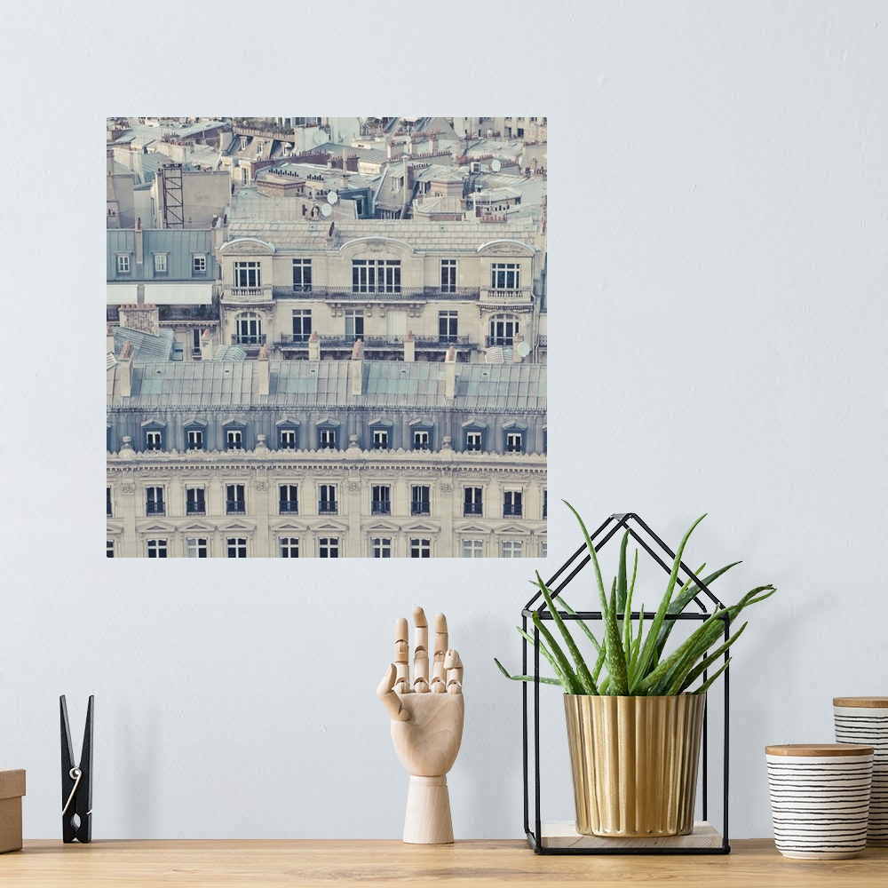 A bohemian room featuring Cream colored apartments with grey blue roofs in Paris, France.