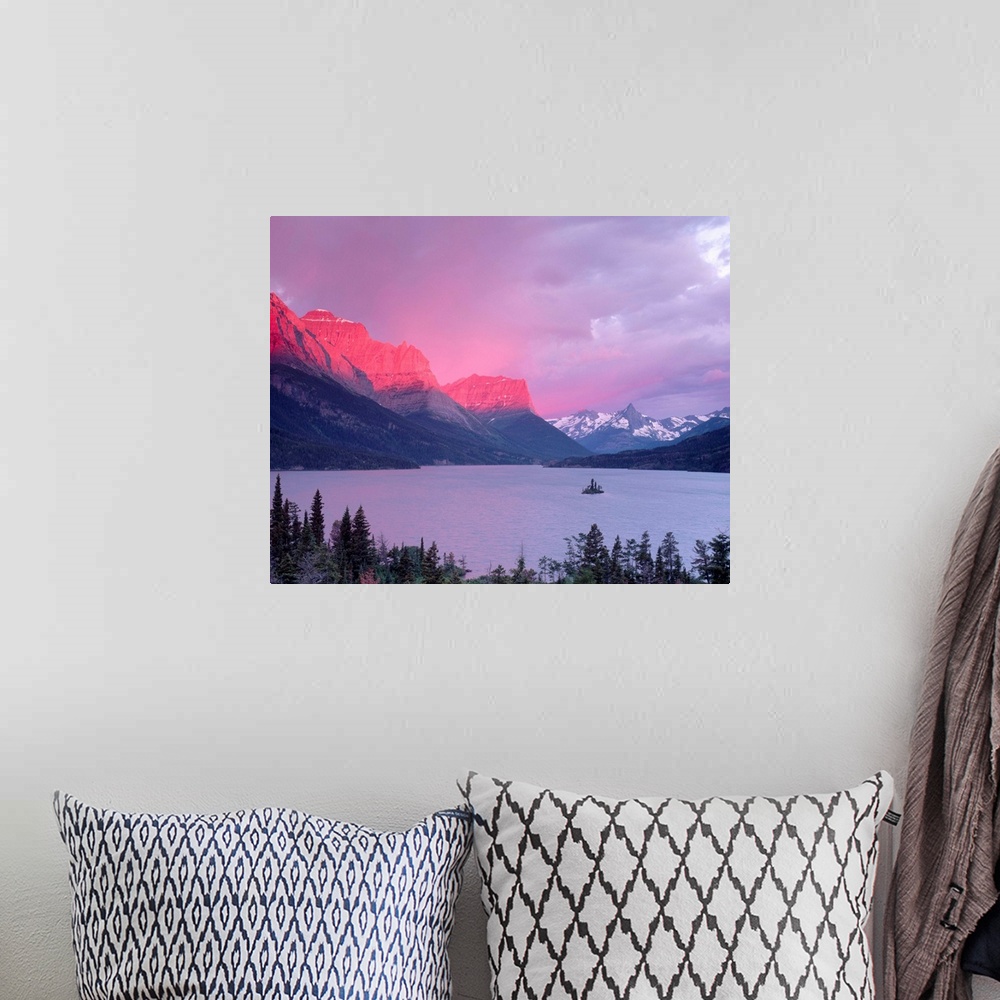 A bohemian room featuring Dawn sunlight illuminates the Rocky Mountains above Saint Mary Lake.