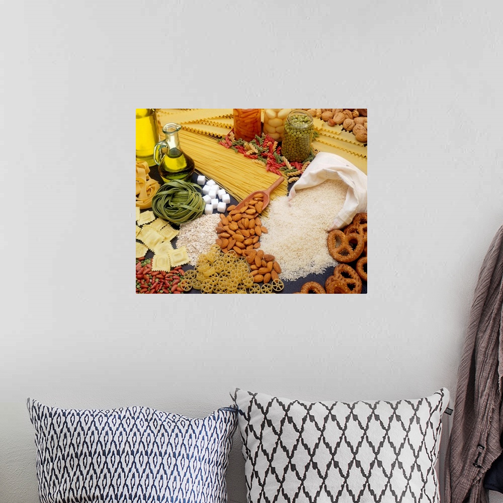 A bohemian room featuring All different types of pasta, nuts and beans are scattered about on a flat surface.