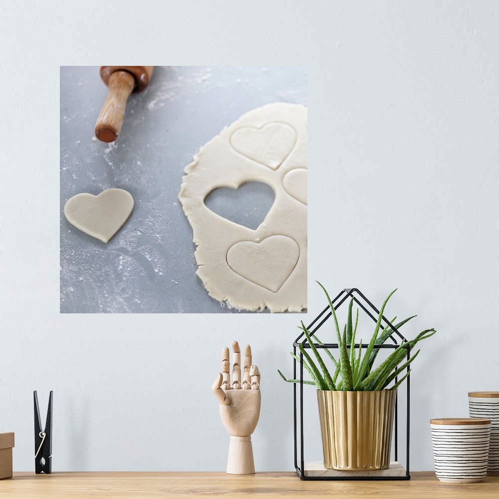 A bohemian room featuring Heart shape cut out of a sheet of rolled out cookie dough