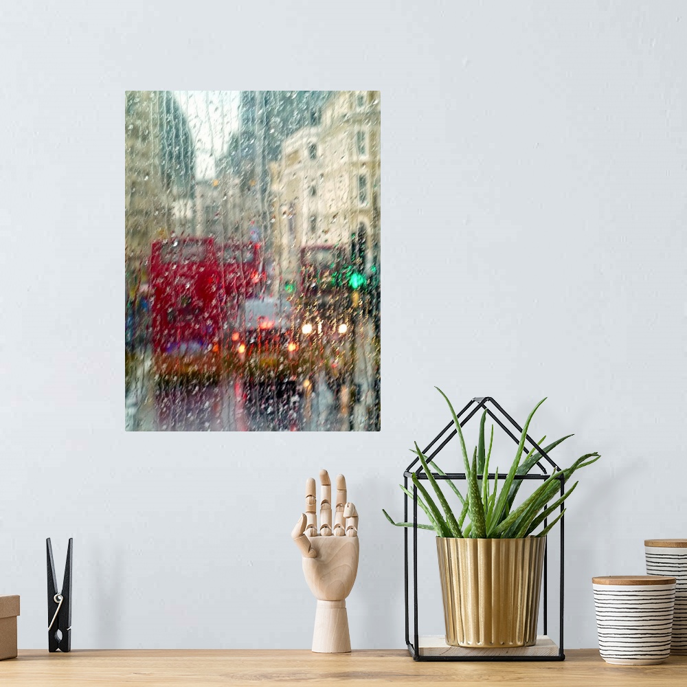 A bohemian room featuring View of red double Decker buses and yellow taxis in rain in London Piccadilly Circus.