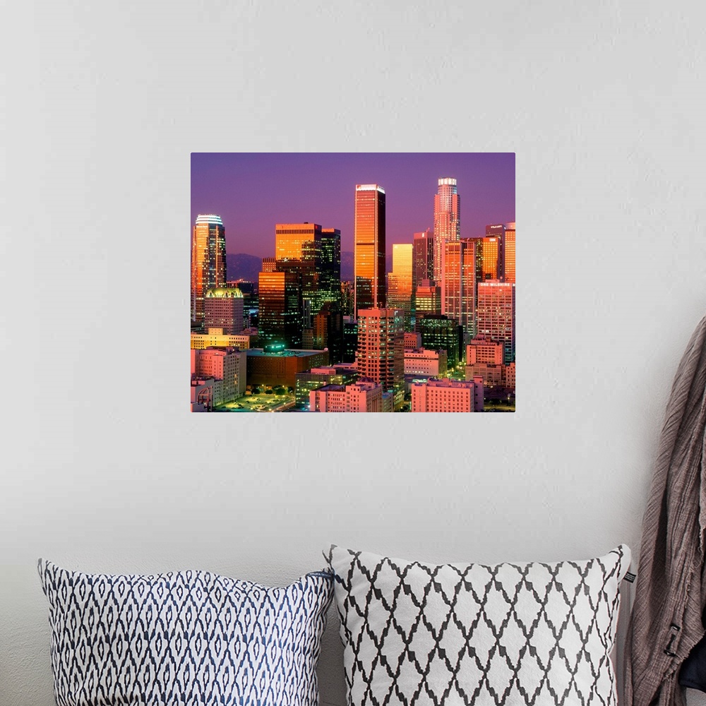 A bohemian room featuring Landscape, close up photograph on a large wall hanging of brightly lit skyscrapers in downtown Lo...