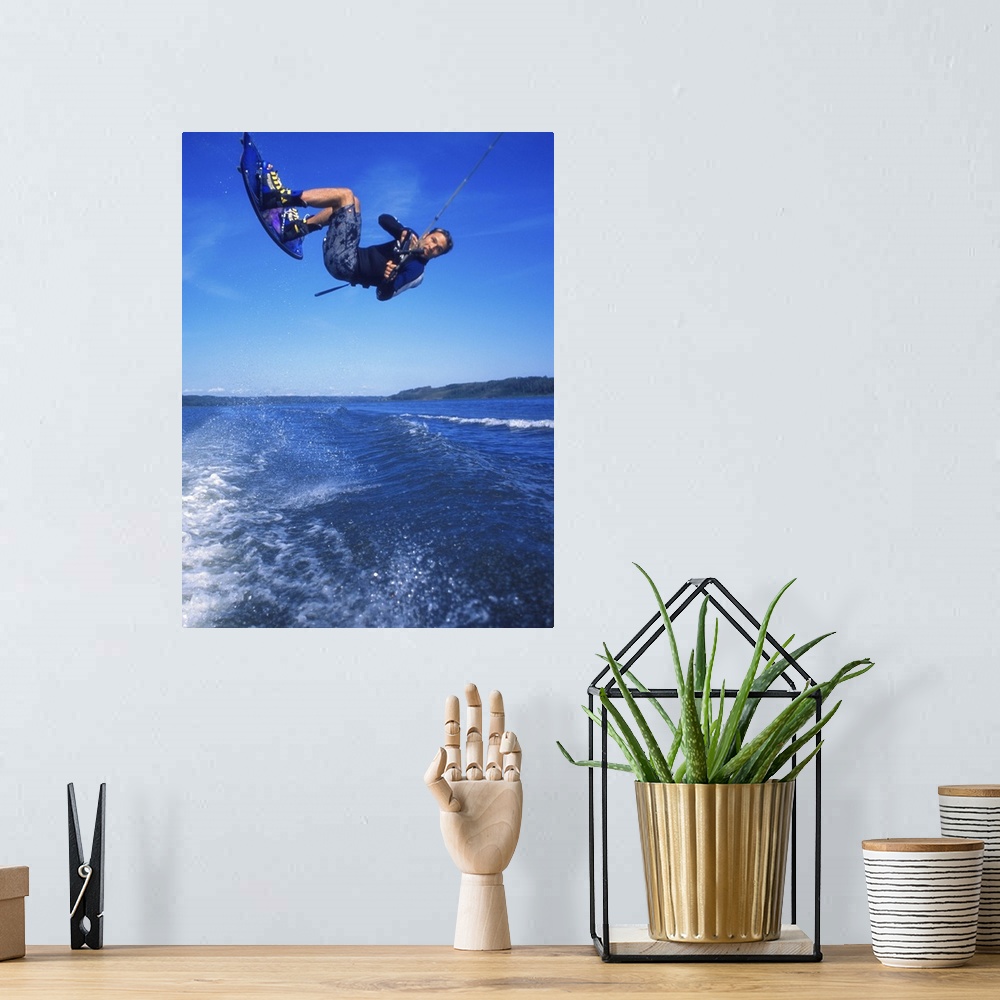 A bohemian room featuring Man wakeboarding on Coal Lake Alberta Canada